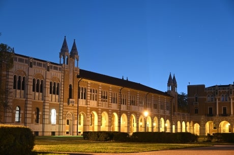 Herzstein Hall lit up at dusk.