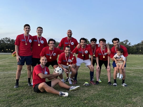 Group of students holding a trophy.