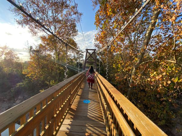 Woman walking on a bridge.